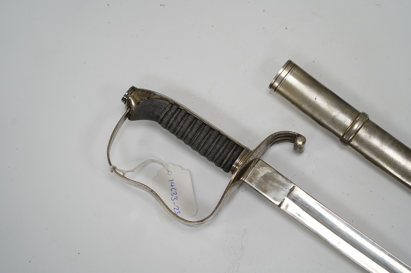 An 1861 Austrian sabre with intaglio initialled hilt and Solingen blade, in its steel scabbard, plated overall, blade 76cm. Condition - good